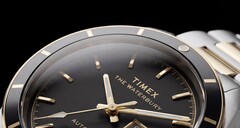 Close-up of the black-dial Timex Waterbury Heritage Automatic showing its faceted luminous hands, hour markers, day-date display, and black bezel.