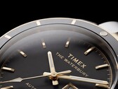 Close-up of the black-dial Timex Waterbury Heritage Automatic showing its faceted luminous hands, hour markers, day-date display, and black bezel.