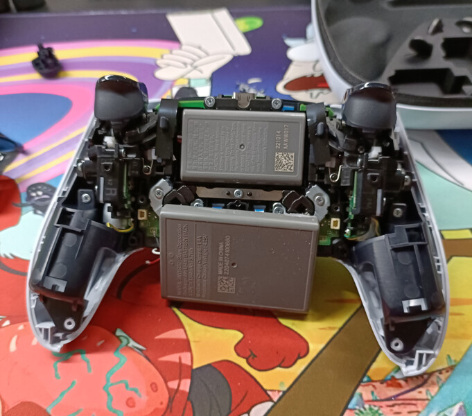 The DualSense Edge in front of the battery included in the DualSense controller. (Image source: @buddscontroller)