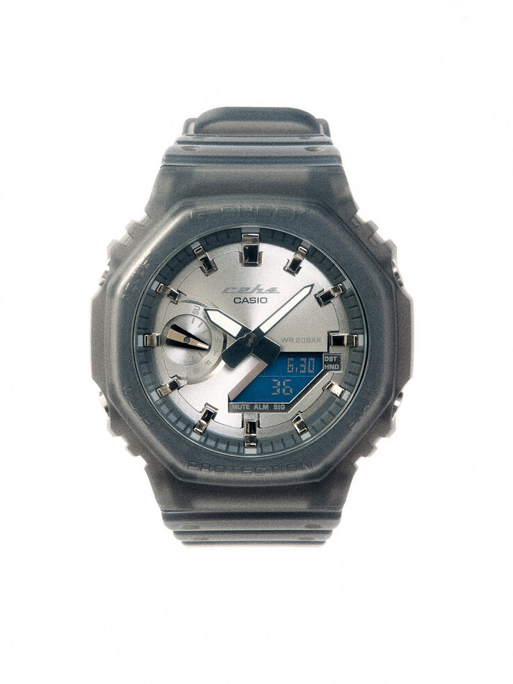 The GA-2100 pairs a brushed silver dial with a translucent smoky-gray bezel and strap for a distinctly retro-futurist look.