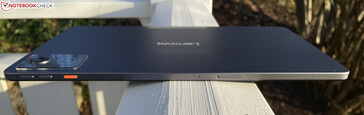 Top: volume rocker, action button, microphones, microSD/SIM slot