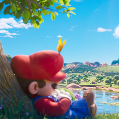 In a quiet moment before cosmic adventure, Mario naps beneath a technicolor tree—teasing the calm before the interstellar storm in The Super Mario Galaxy Movie.