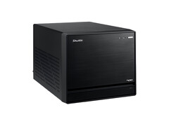 The image shows a head-on view of the Shuttle XPC Mini PC, which looks like a black cube with a minimal design.