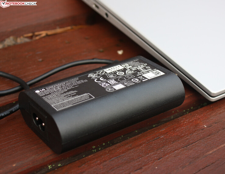 The 65-W power adapter weighs 292 grams/~0.64 lbs (with the cable)