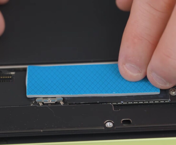 Installing a thermal pad on the MacBook Neo CPU for improved cooling