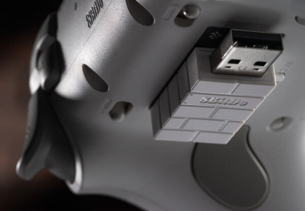 The 2.4GHz adapter attaches magnetically to the underside of the Ultimate 3C+ wireless controller.