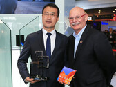 A Huawei representative accepts the award from John Hoffman, the CEO of GSMA. (Source: Huawei)