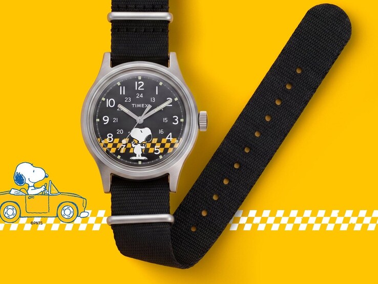 Peanuts x Timex MK1 watch with a black dial featuring Snoopy and a yellow-and-black checkered graphic, shown with its black fabric strap against a yellow background.