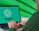 Person typing on a laptop that shows the ChatGPT logo