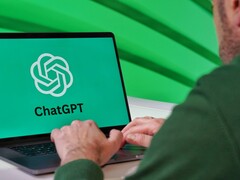 Person typing on a laptop that shows the ChatGPT logo