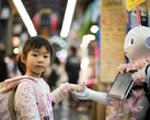 Bill Gates: AI set to eliminate global doctor and teacher shortages. Pictured: A girl holding a robot's hand (Image source: Andy Kelly, Unsplash)