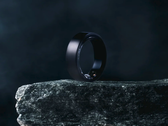 The Soxai Ring 2, pictured in a matte black finish on the edge of a rock against  a dark background. (Image source: Soxai)