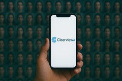 Smartphone with Clearview AI on it, face database in the background (Image source: AI-generated)