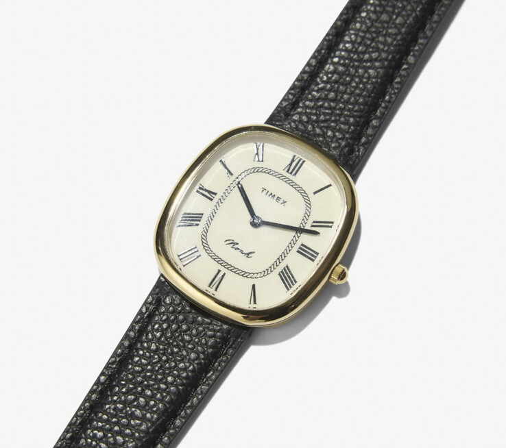 Close-up of the gold-tone Noah × Timex Boatswain, showing its Roman numeral dial and rope-pattern inner track.