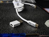 A braided metal USB type-C-to-C cable and type-A-to-C adaptor are included. 