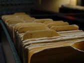 A row of old ring binders in a dimly lit room.