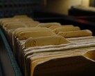A row of old ring binders in a dimly lit room.