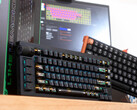 Lemokey L1 HE Keychron K4 HE Hall effect gaming keyboards on a desk in front of a box and laptop