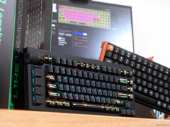 Lemokey L1 HE Keychron K4 HE Hall effect gaming keyboards on a desk in front of a box and laptop