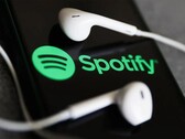 An image showing headphones on a phone with the Spotify logo. (Image source: Jakub Porzycki/NurPhoto - Getty Images)