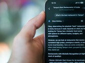 Someone using their phone to find a restaurant using Gemini
