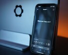 Smartphone with the ChatGPT app open in front of a screen