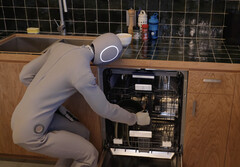 The humanoid home robot 1X Neo is loading a dishwasher (Image source: WSJ on YouTube/screenshot).