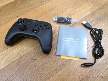 Packaging includes controller, 2.4 GHz receiver (for PC), manual, and USB-C to USB-A charging cable