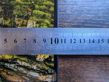 Narrow side bezels with thicker top and bottom bezels