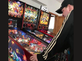 New Zealand pinball machine collector Kim Michael Dozier playing an Iron Maiden pinball Machine at Kimzone