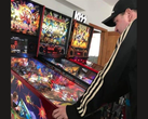 New Zealand pinball machine collector Kim Michael Dozier playing an Iron Maiden pinball Machine at Kimzone