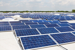 A solar panel array stacked on multiple roofs