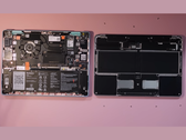 A torn-down Framework 12.2 laptop next to a MacBook Neo