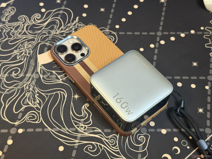 The five port Ugreen Nexode Pro 160W on top of iPhone 16 Pro Max