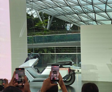 Omoway OMO X self-balancing electric motorcycle displayed on stage.