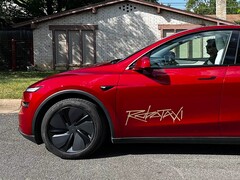 Tesla Robotaxi ride-share platform logo on a Model Y.