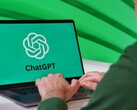 A man is typing on a laptop with the ChatGPT logo visible on the screen