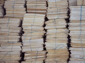 Tall stacks of bundled paper files, tied with string