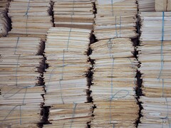 Tall stacks of bundled paper files, tied with string