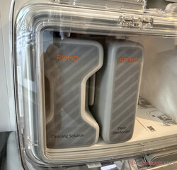 The two detergent containers behind Plexiglas