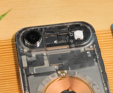Close-up of transparent iPhone Air showing the exposed camera module, flash, and internal components beneath the clear back panel. (Image source: Phone Repair Guru via YouTube)