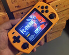 A picture of a Powkiddy P36S retail unit in its orange finish.