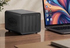 The image shows the Terramaster D8 Hybrid 2 NAS next to a laptop on a wooden desk