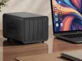 The image shows the Terramaster D8 Hybrid 2 NAS next to a laptop on a wooden desk 