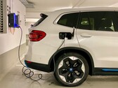 An electric car plugged in at a charging station (Image source: Eren Goldman via Unsplash)