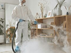 A woman steam-cleaning her house. (Image source: Michelangelo Buonarroti - Pexels)