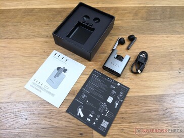 Packaging includes instructions, manual, short USB-C charger, charging base, and earbuds