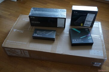 Package contents: Table (large package) and accessories (monitor arms, laptop holder, RGB LED, cable management)