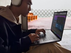 A man in front of a laptop (Image Source: Apple)