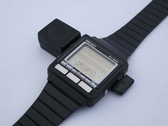 The WristMac on its 'bi-directional' Macintosh adapter. (Image source: Aroged)